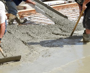 Workers pouring concrete