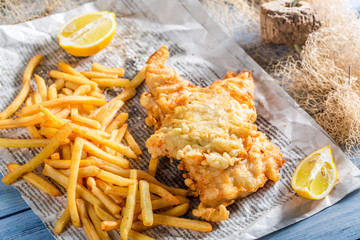 Tasty fish cod with chips served in paper