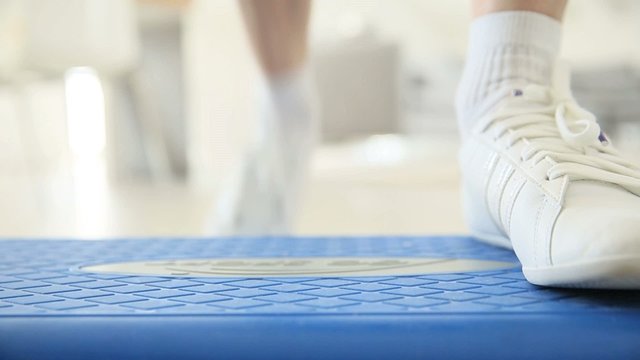 Closeup on woman's sports shoes during step exercises