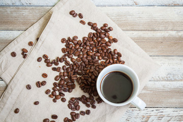 Top view of a cup of coffee with coffee beans