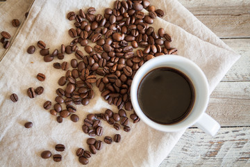 Top view of a cup of coffee with coffee beans