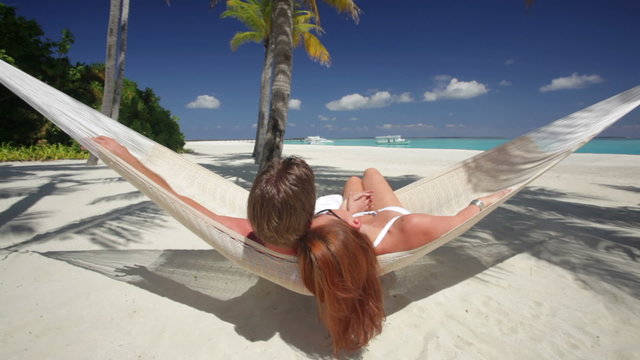couple in hammock on tropical island