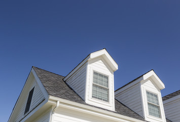 Roof of House and Windows Against Deep Blue Sky