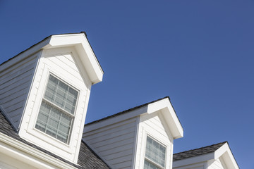 Roof of House and Windows Against Deep Blue Sky