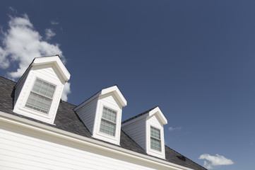 Roof of House and Windows Against Deep Blue Sky