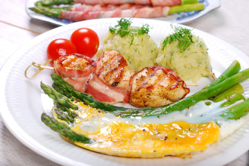 dinner with green asparagus baked on eggs