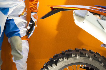 Closeup image of a motocross biker protective clothing