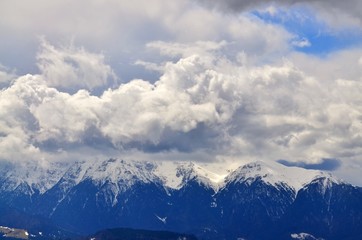 Naklejka premium Big clouds on top of Bucegi mountain peak in winter season