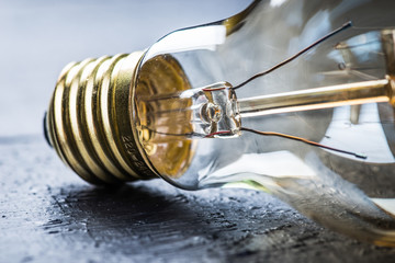 Tungsten bulb on a black wooden table