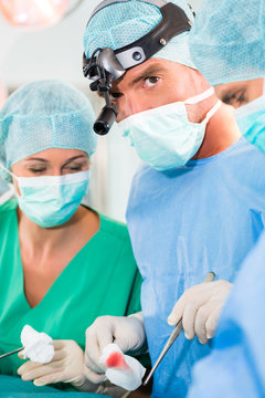 Surgeons operating in operation theater room