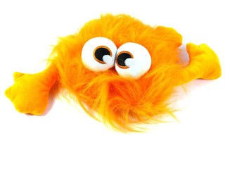 Orange toy monster with long hair and bulging eyes
