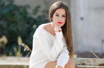 Lady sitting outside with passive look