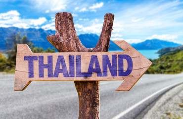 Thailand wooden sign with road background