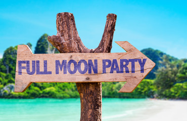Full Moon Party wooden sign with beach background