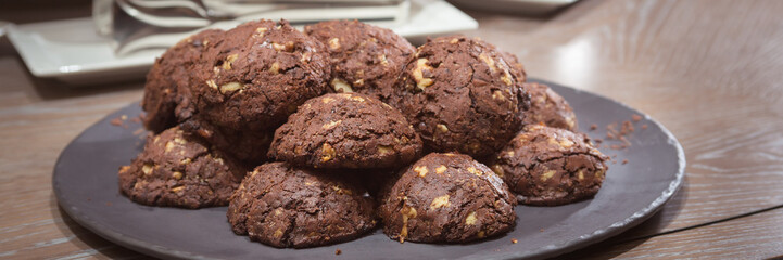Chocolate and nut cookies on wooden table