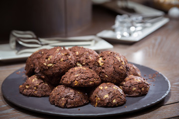 Chocolate and nut cookies on wooden table