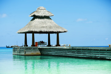 Boardwalk to arbor over blue ocean in Baros Maldives