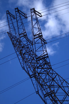 High-voltage electricity pylon, blue sky