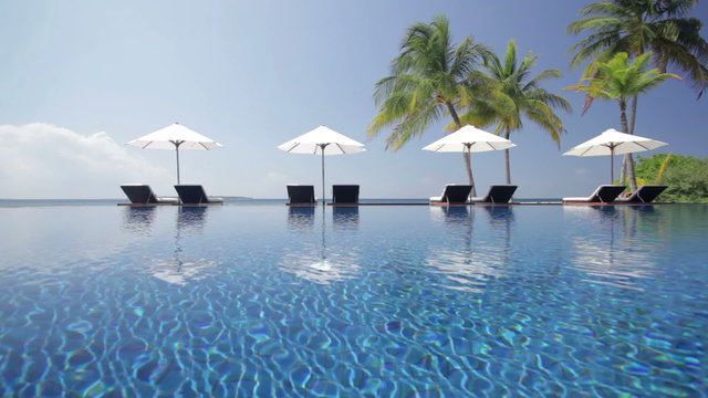 pool scenery with four parasols
