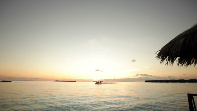 waterplane taking off at sunrise