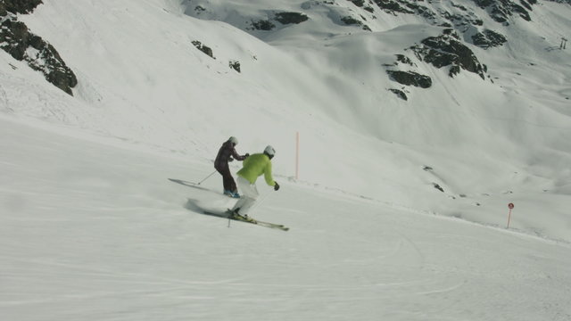 two skiers skiing on ski piste