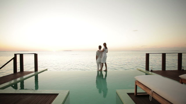 couple on private pool watching sunset
