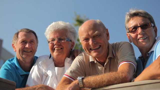 four happy smiling seniors outdoor
