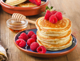 Small pancakes with fresh berries and  butter