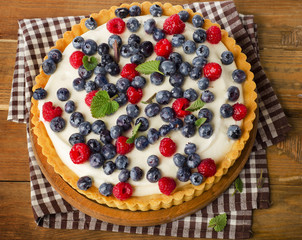 Cake with  fresh raspberries and blueberries.