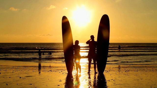 Surfers at sunset