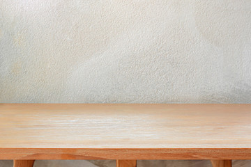 Wood table top on concrete wall background