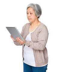 Old woman use of digital tablet