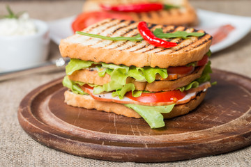 Classic club sandwich with bacon and vegetables