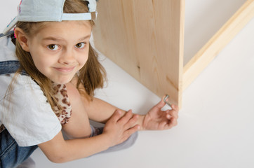Girl in overalls collector furniture screw spins