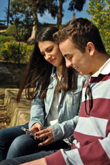 Young people watching their mobile phones