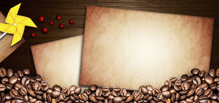 coffee beans and paper old on a wooden table. Dark background