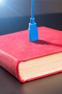 Usb cable plugged into a book