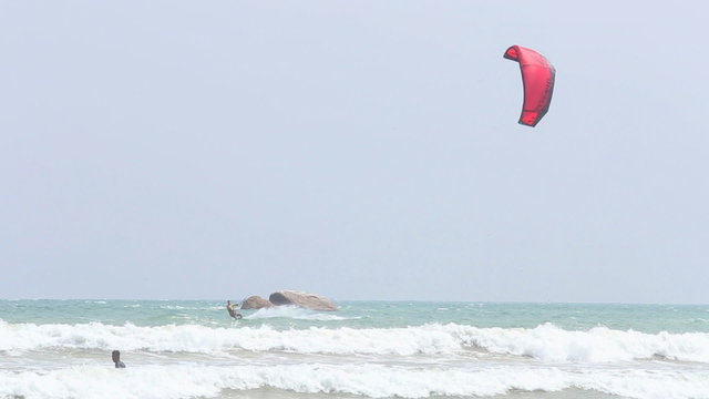 WELIGAMA, SRI LANKA - MARCH 2014: Kitesurfer jumping in the waves and surf in Weligama, a well-known spot for sport lovers.