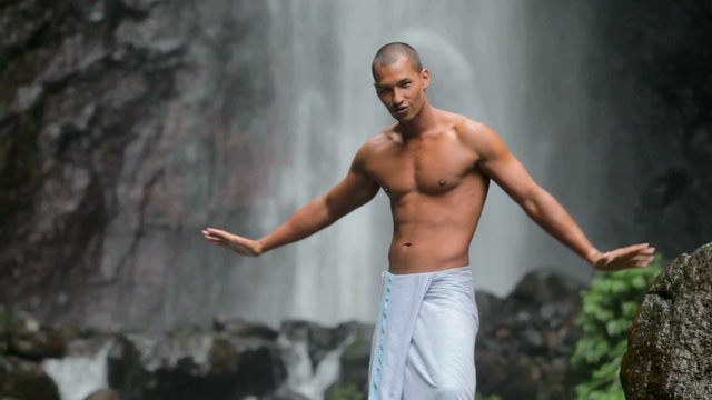 man at waterfall
