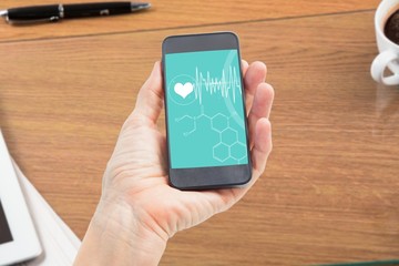 Composite image of woman showing black smartphone screen