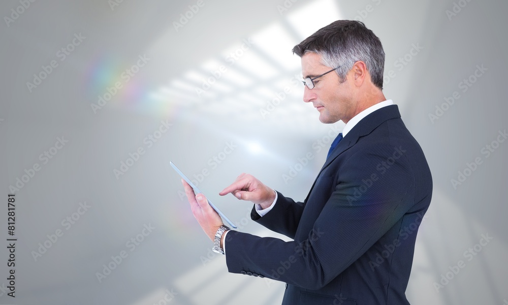 Poster composite image of mid section of a businessman touching tablet