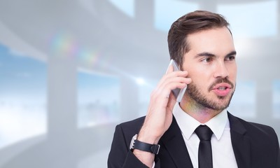 Composite image of smart businessman speaking on the phone