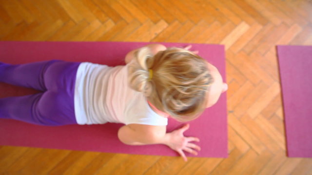 Women doing yoga class in hall