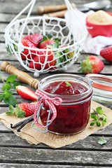 Homemade delicious strawberry jam on a rustic wooden table