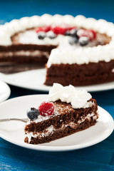 Homemade chocolate cake with cream and berries