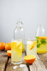 Naklejka na ściany i meble Cold orange soda in a glass on a wooden background