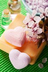 Spa setting with soap, bath salt, essential oils and flowers