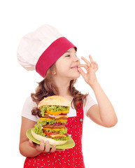 little girl cook with big hamburger and ok hand sign