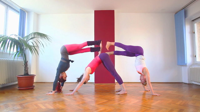 Women doing yoga class in hall