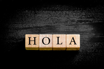Word HOLA isolated on black background with copy space © stanciuc